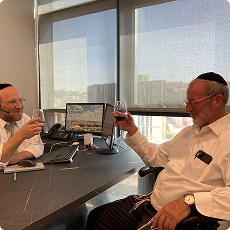 L'chaim with the Chairman of Chaim V'Chessed in the new offices